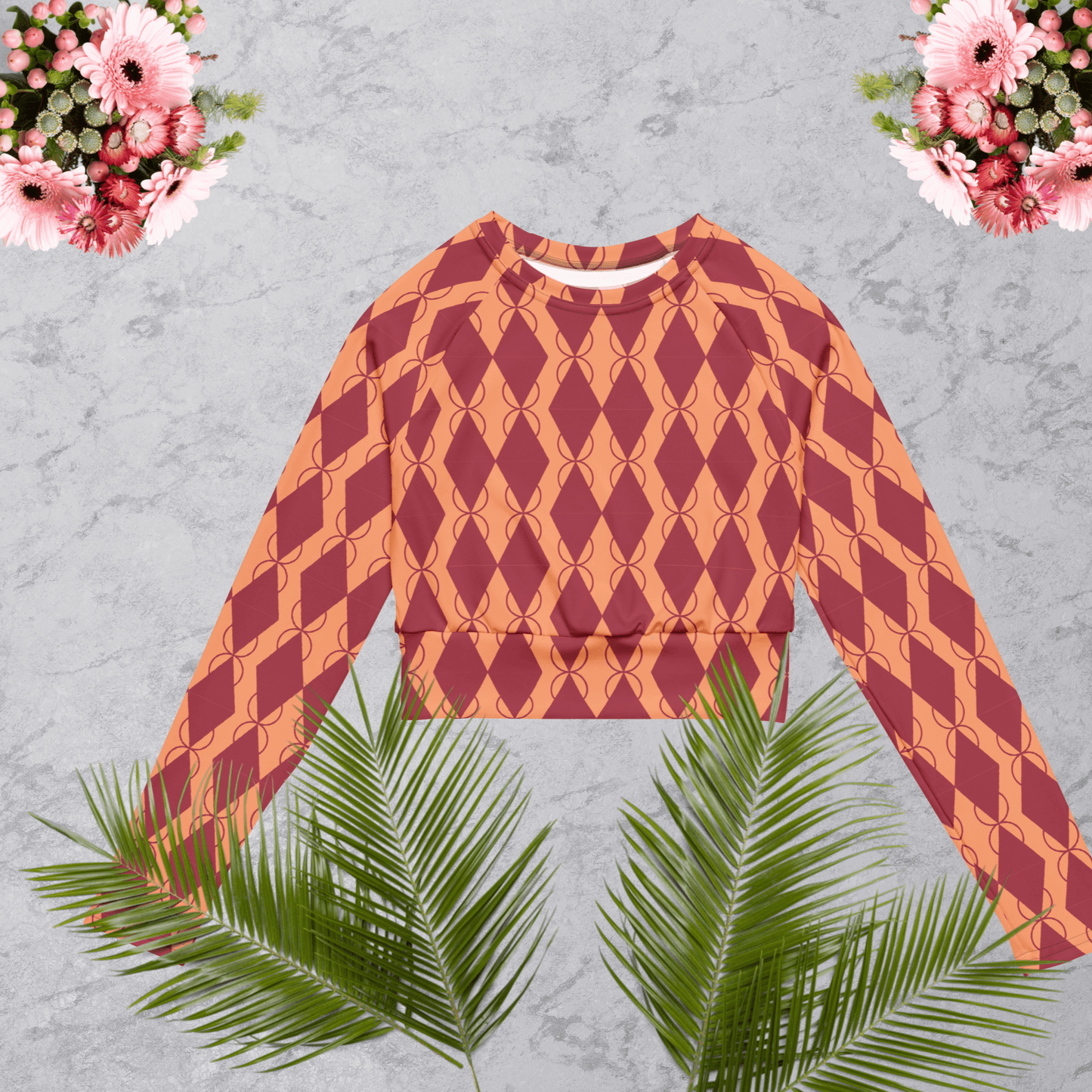 Light coral and maroon argyle women’s recycled long-sleeve crop top.