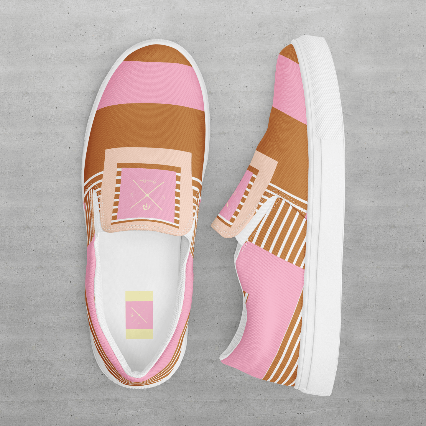 Slip on women’s pink and tan canvas shoes.