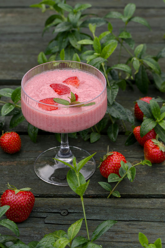 Pink smoothie on a table.