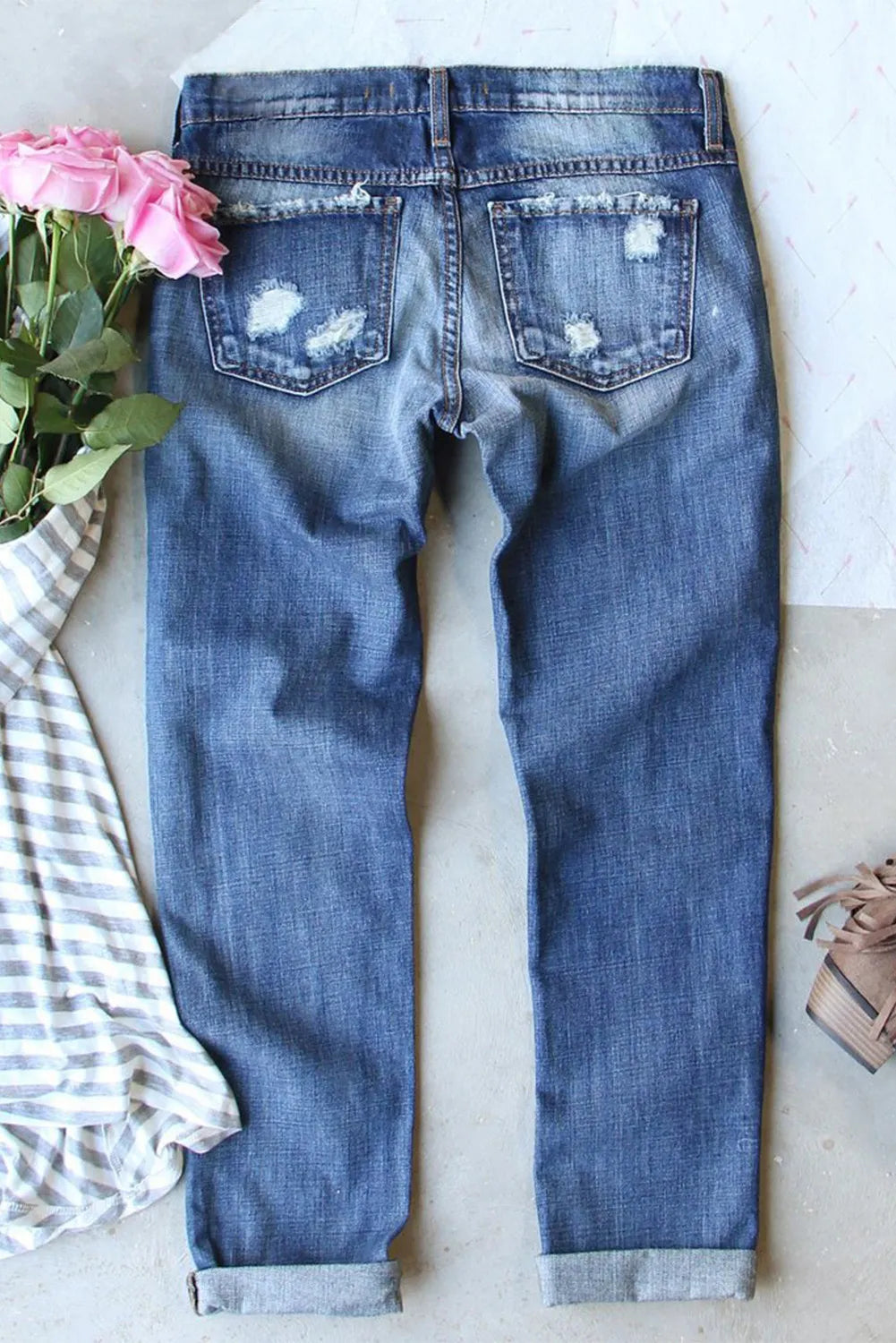 Distressed medium-wash pumpkin women’s denim jeans with pockets.