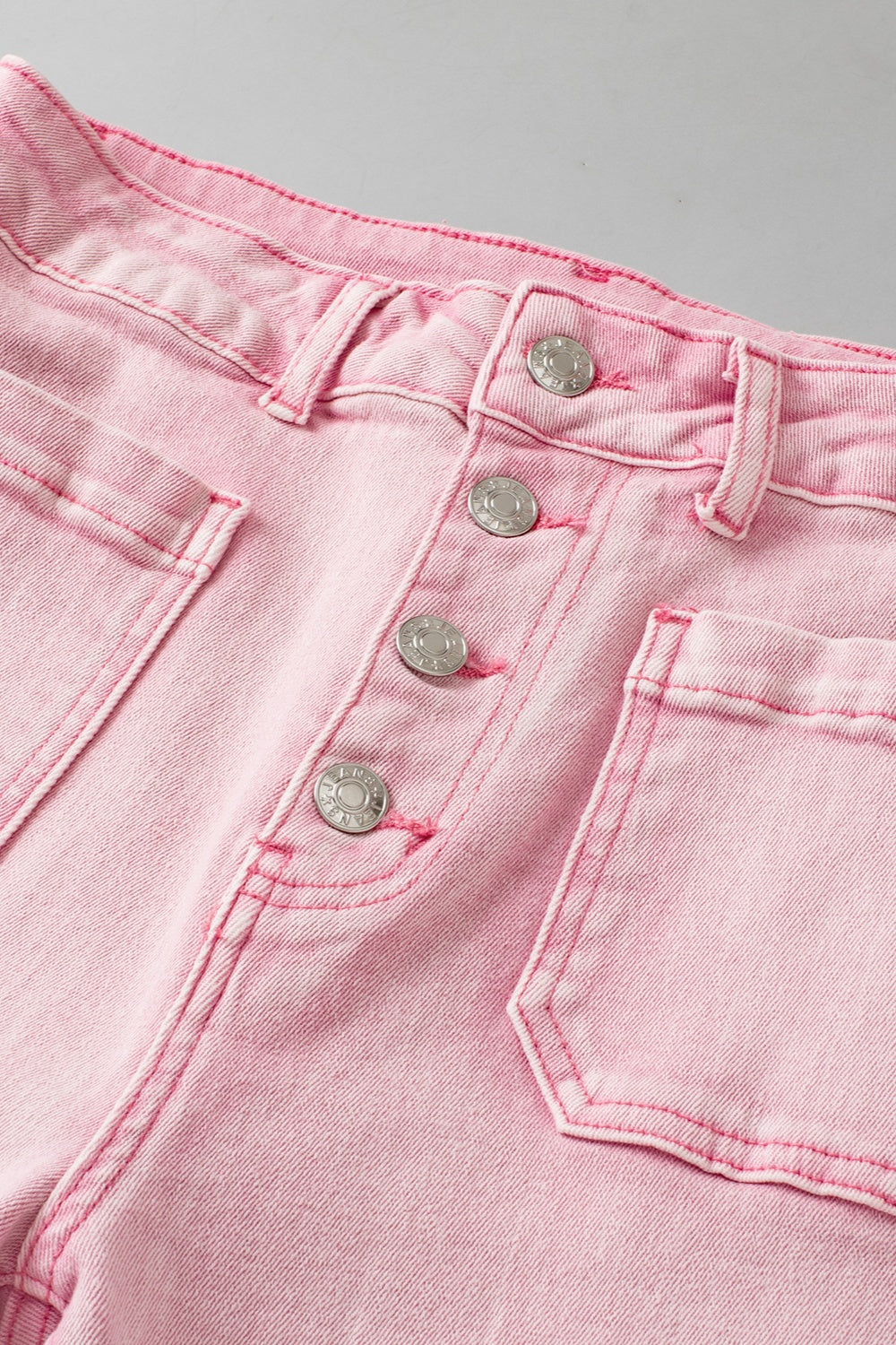 Denim blush pink raw hem women’s jeans with pockets.