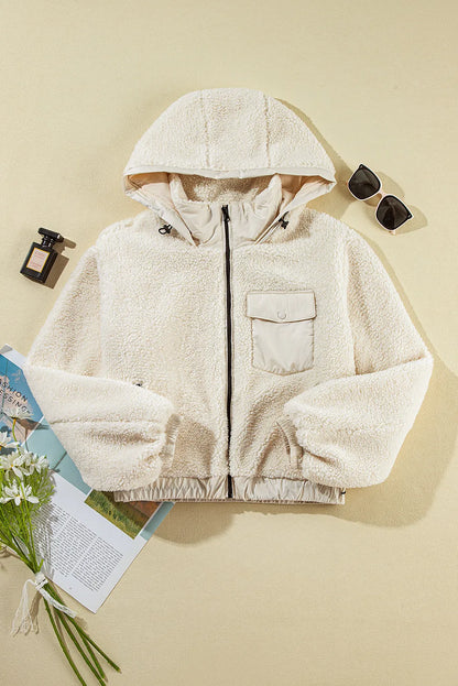 Puffer pocketed zip up hooded women’s jacket.