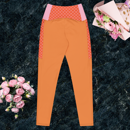 Orange and multi-color women’s crossover leggings with pockets.