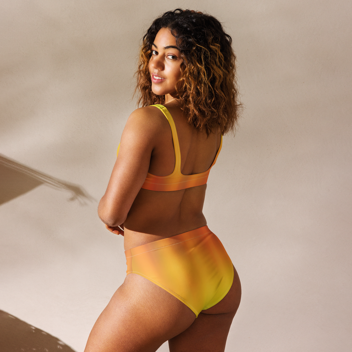 Orange and yellow recycled women’s high-waisted bikini set.