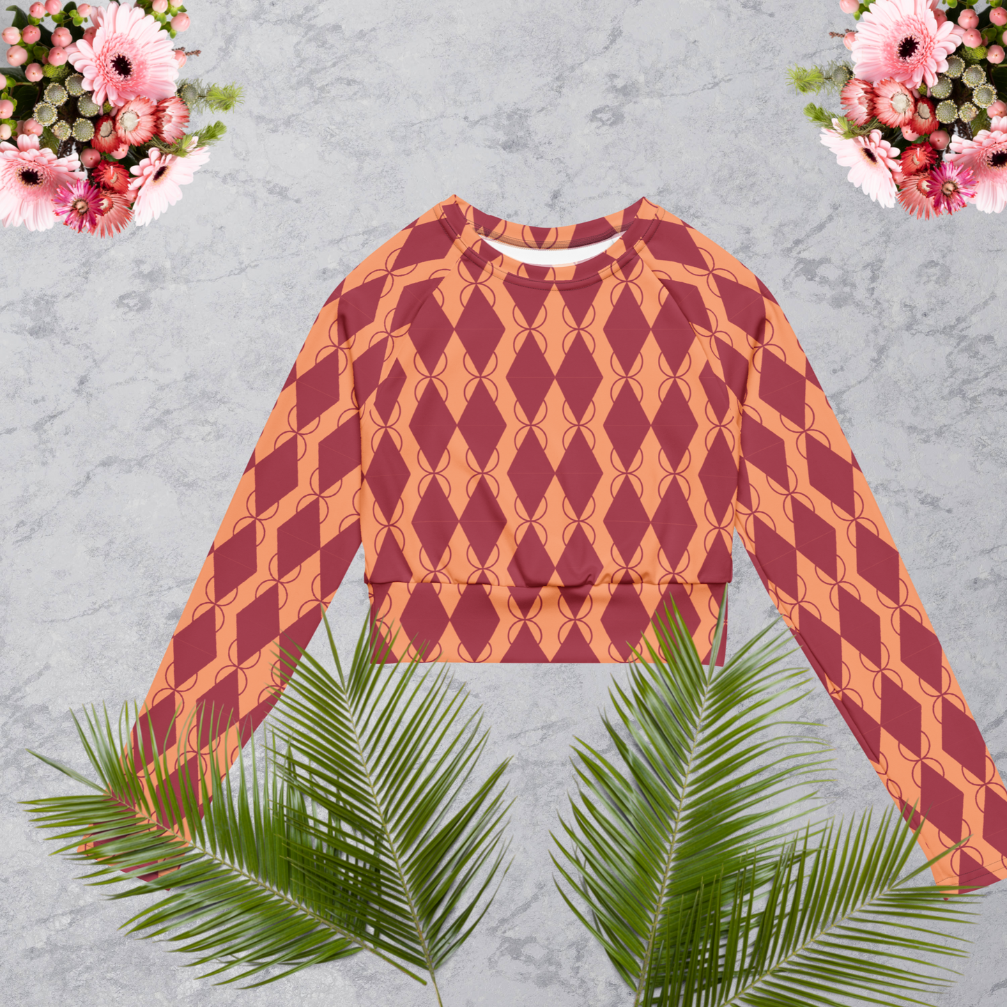 Light coral and maroon women’s recycled long-sleeve crop top.