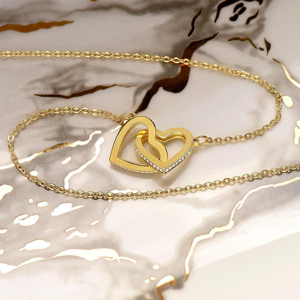 Heart of two intertwined white or yellow gold cz necklace.