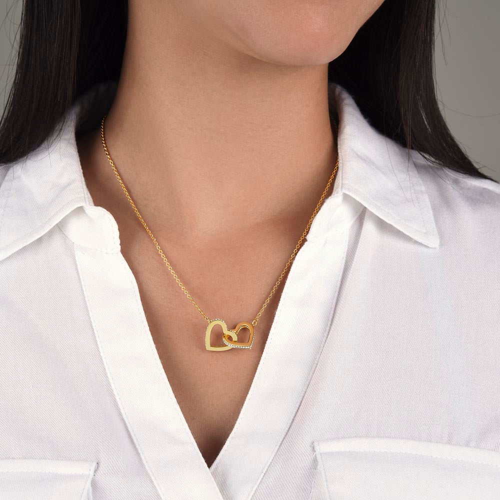 Heart of two intertwined white or yellow gold cz necklace.