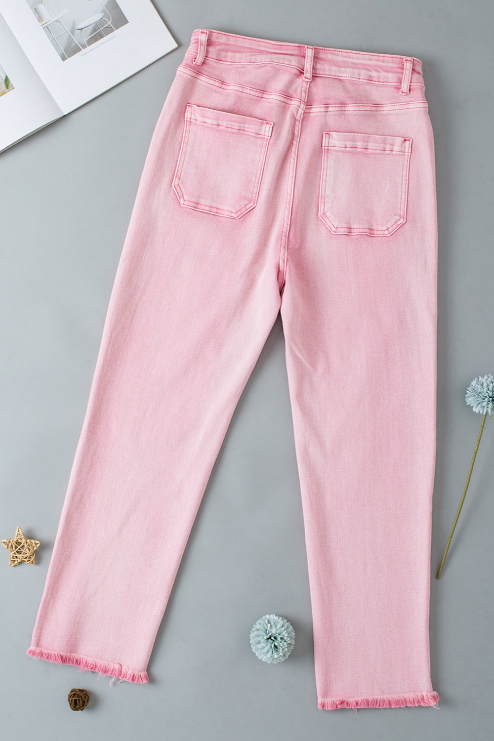 Denim blush pink raw hem women’s jeans with pockets.