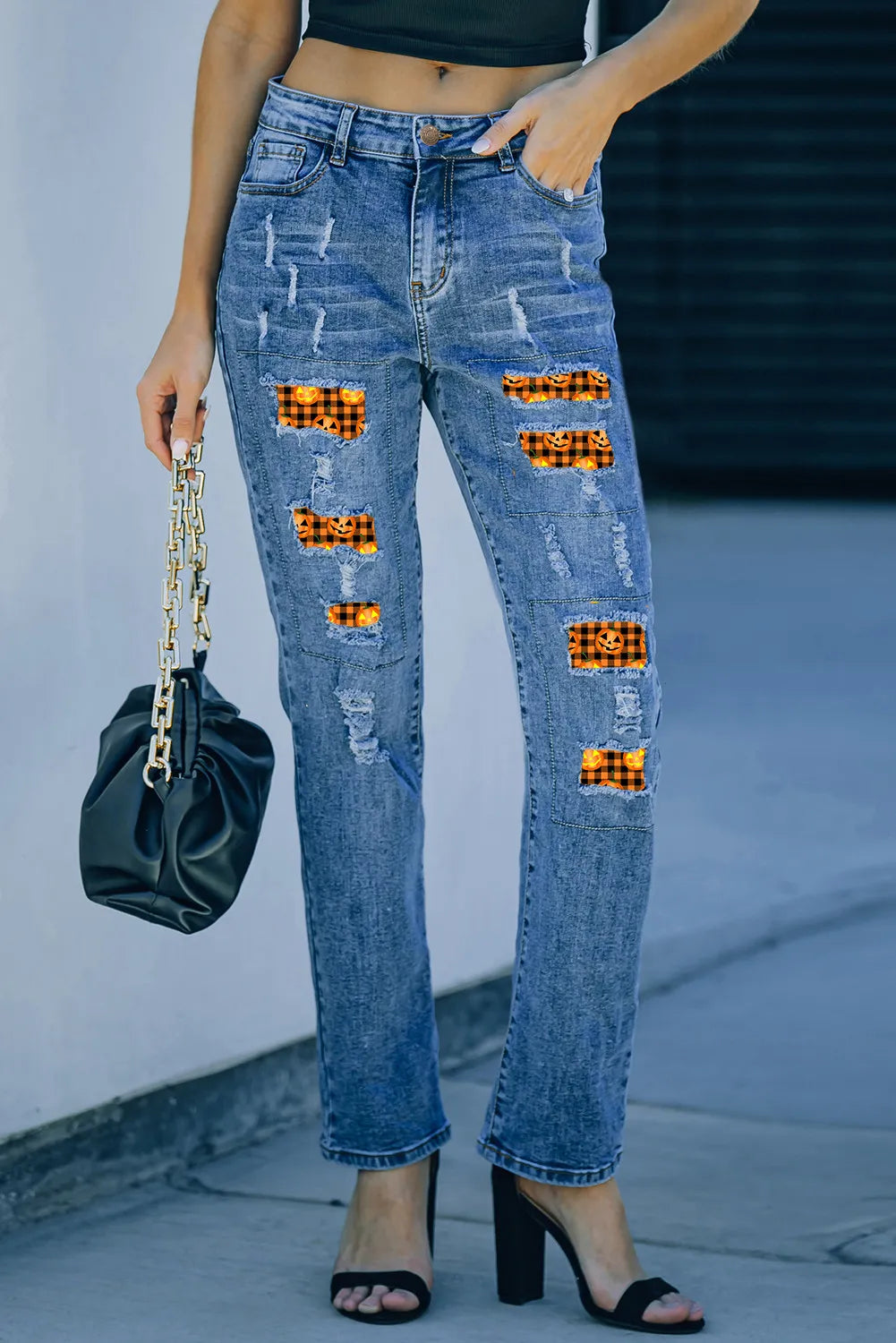 Distressed medium-wash pumpkin women’s denim jeans with pockets.