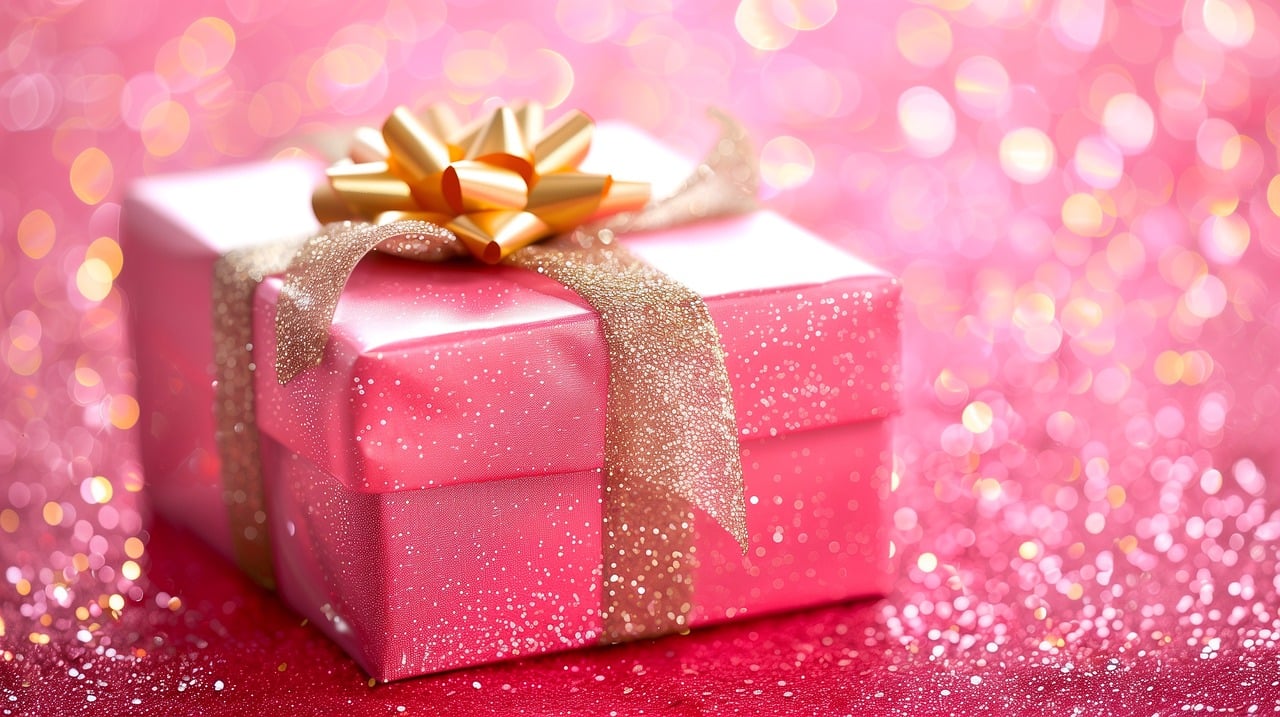 Pink gift box with a gold ribbon.