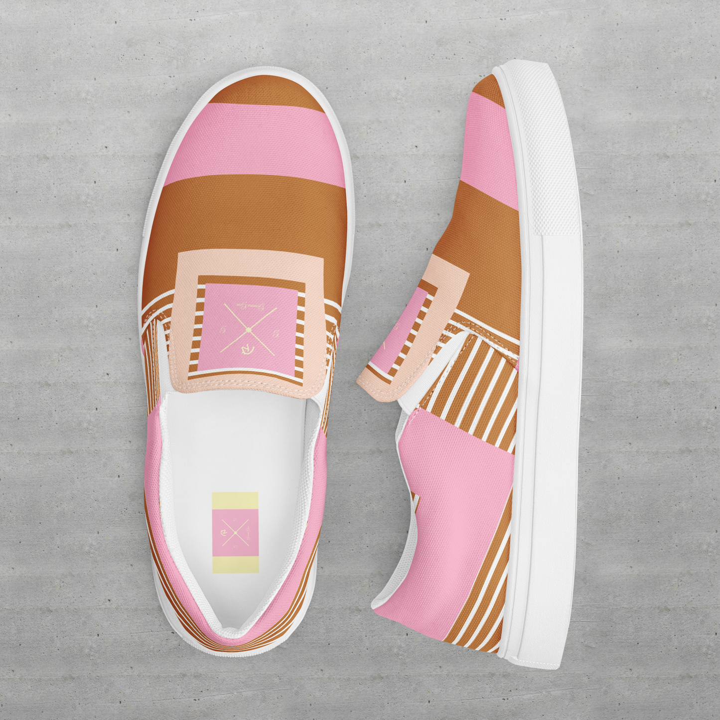 Slip on women’s pink and tan canvas shoes.